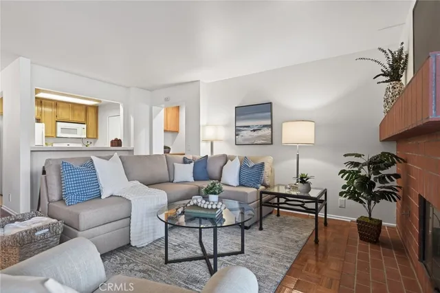 a living room with furniture potted plant and a window