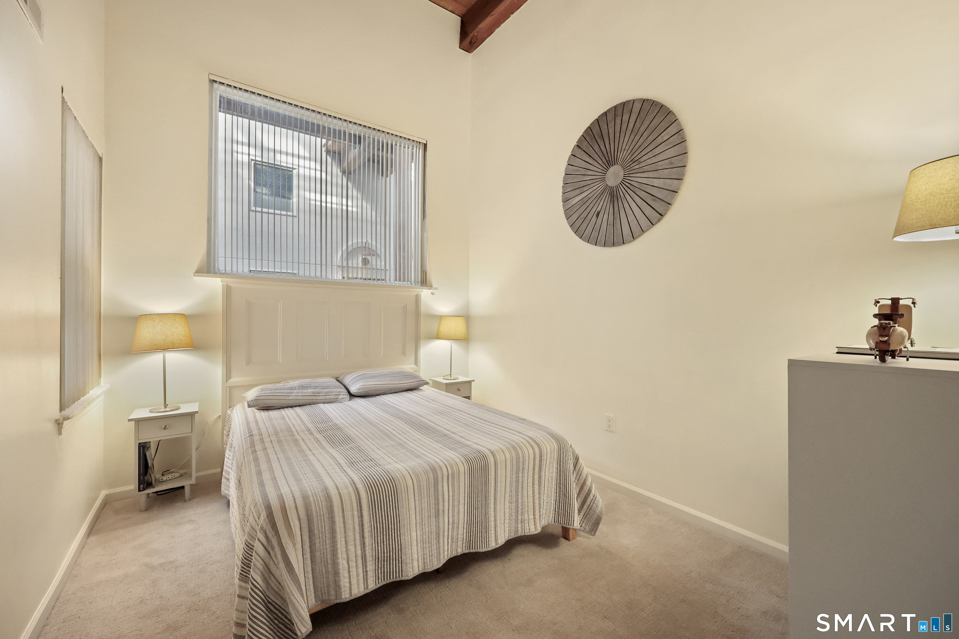 839 Main Street, Unit 40 Torrington, CT 06790 - Photo 11 of 31 a bedroom with a bed and a chandelier