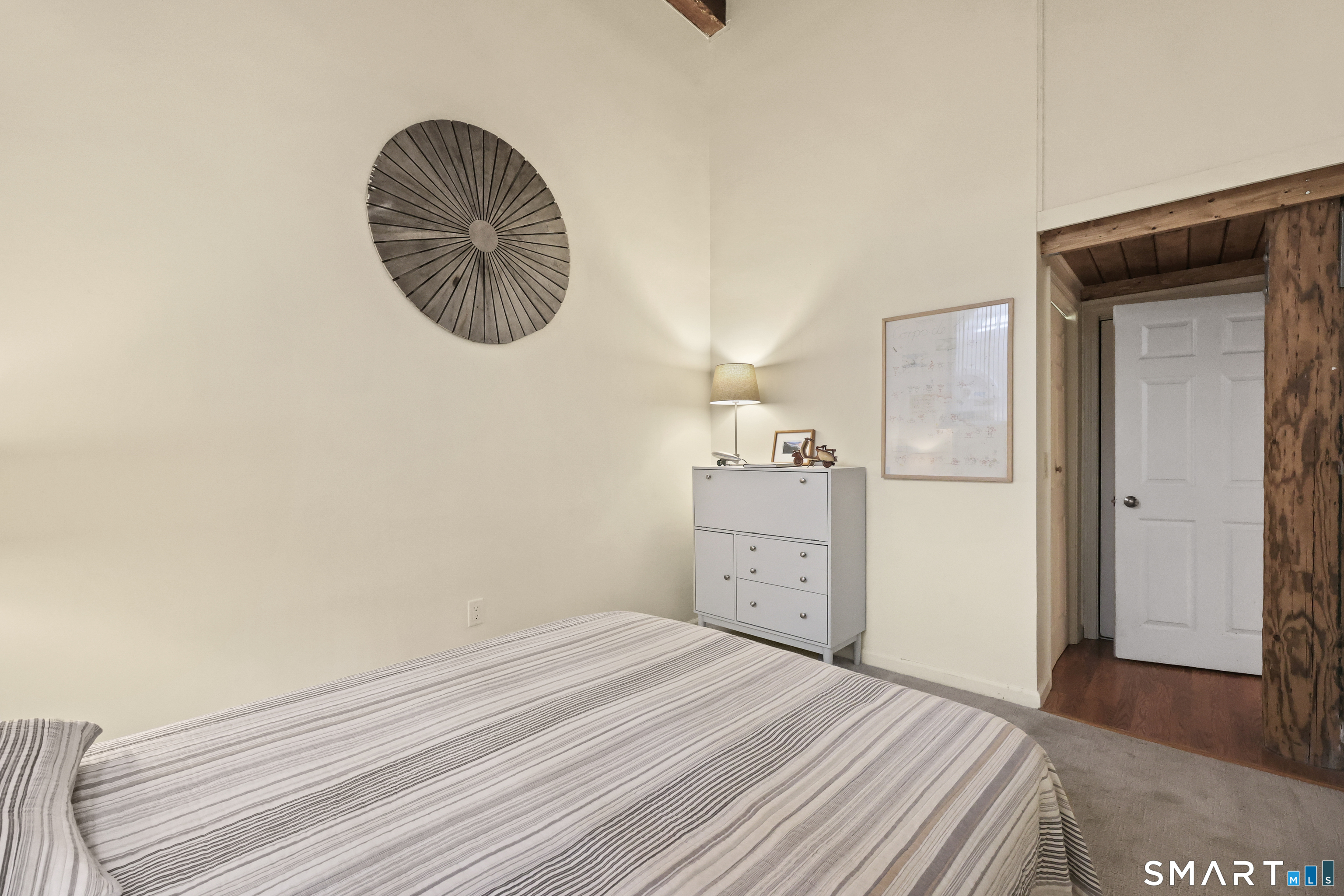 839 Main Street, Unit 40 Torrington, CT 06790 - Photo 13 of 31 a room with a bed and a chandelier