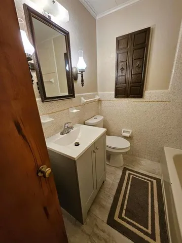 a bathroom with a sink a toilet and mirror