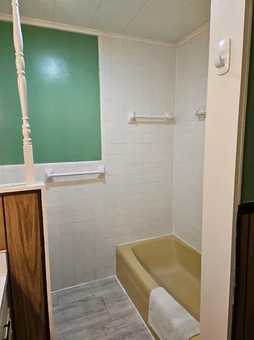 a bathroom with a tub and shower