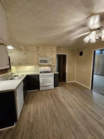 a large kitchen with kitchen island a sink stainless steel appliances and cabinets