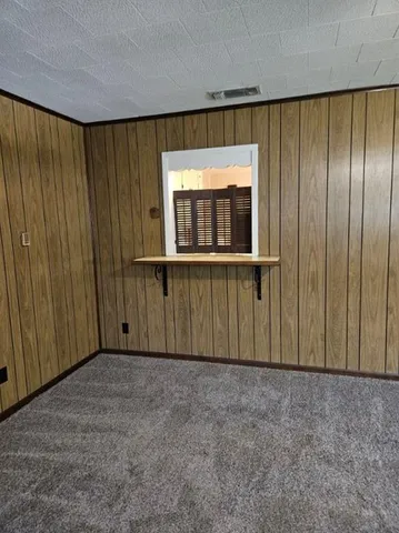 a view of a porch with wooden floor and a window
