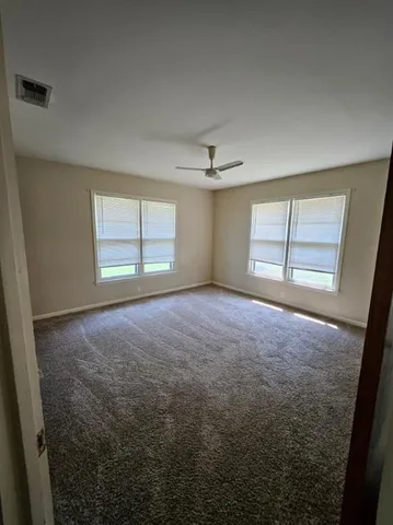 en empty room with windows and closet