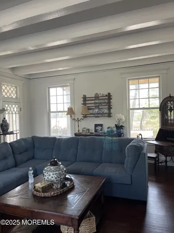 a room with pool table and windows