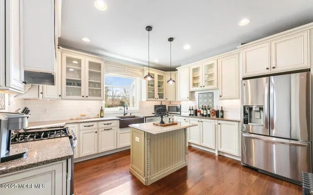 a kitchen with stainless steel appliances granite countertop a sink stove and cabinets