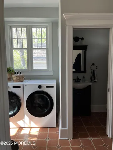 a bathroom with a toilet a sink and mirror