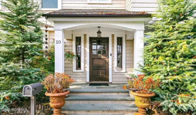 a front view of a house with plants