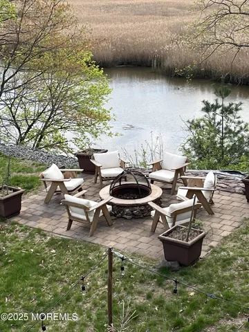 a view of a backyard with swimming pool and sitting area