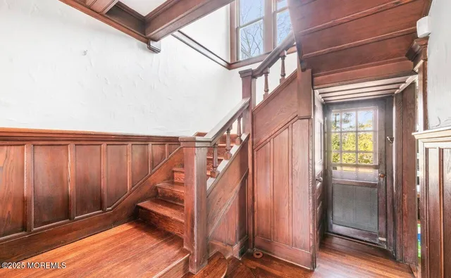 a view of a balcony with furniture and wooden floor