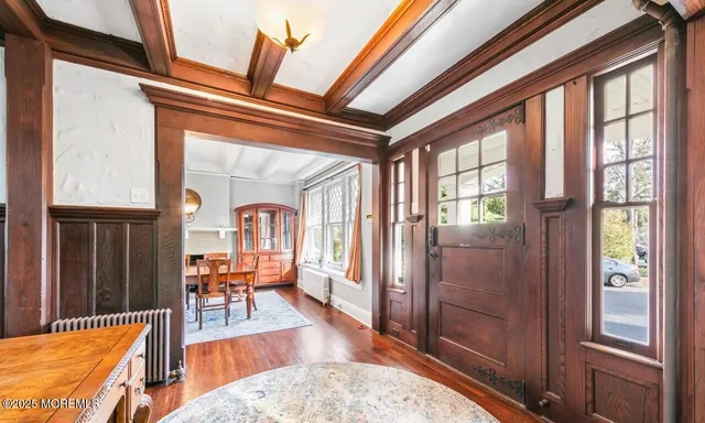 a living room with furniture a rug and a chandelier