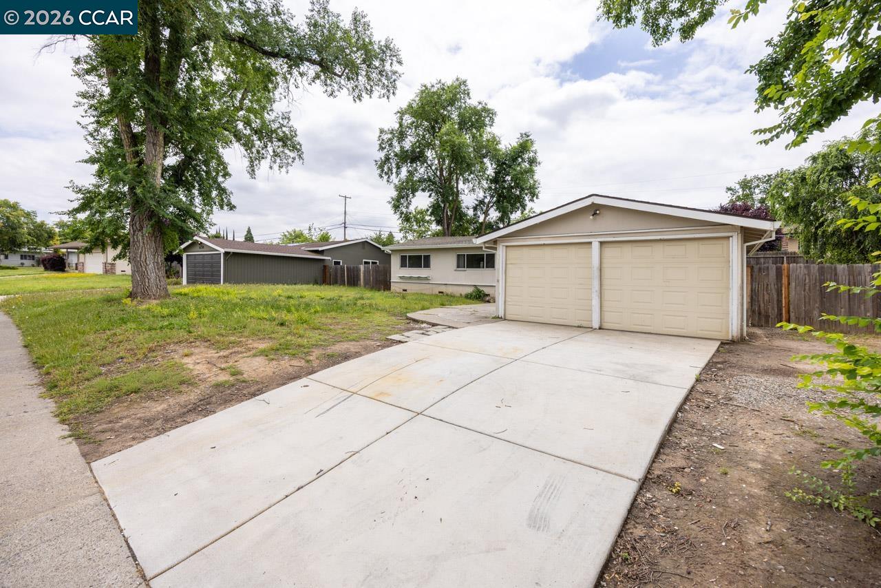6118 Rutland Drive Carmichael, CA 95608 - Photo 2 of 19 a view of a house with a yard and large tree