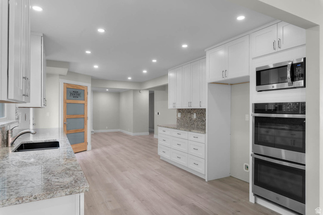 8965 Quail Run Drive Sandy, UT 84093 - Photo 5 of 56 Kitchen featuring stainless steel appliances, white cabinetry, light stone counters, and recessed lighting