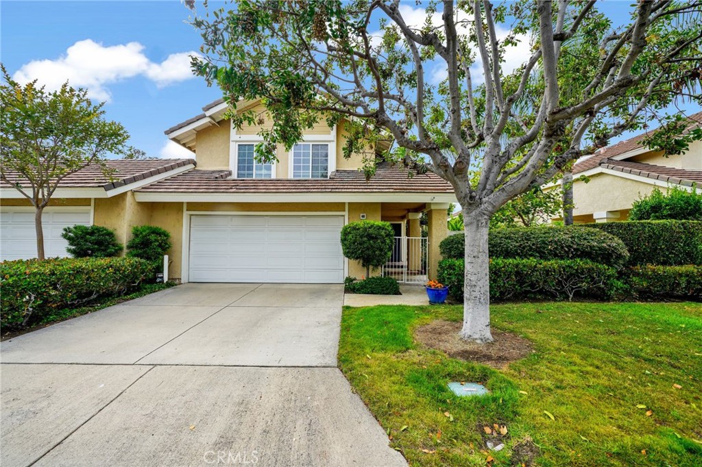 48 Rushingwind, Unit 40 Irvine, CA 92614 - Photo 1 of 1 a front view of a house with garden