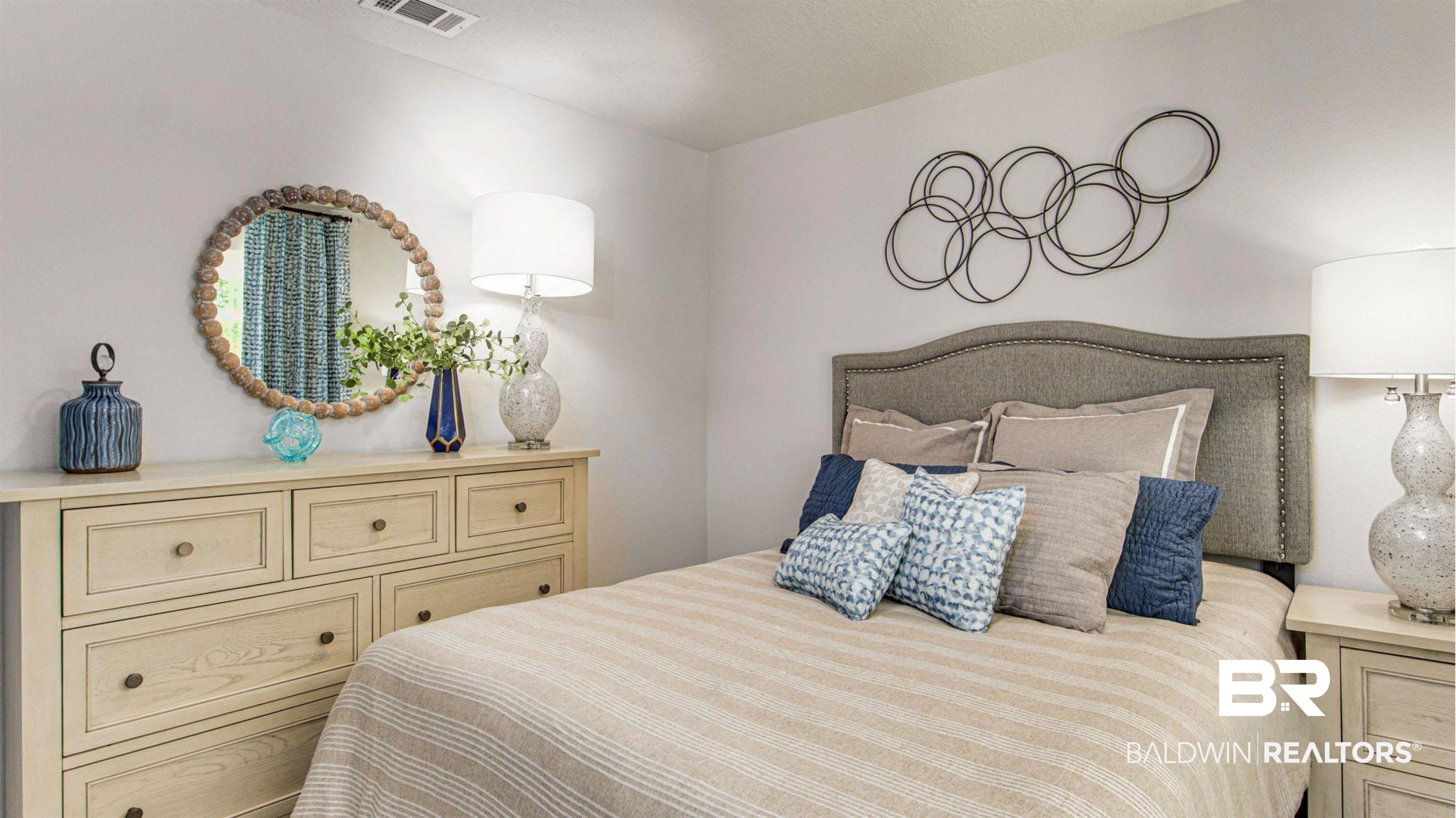 1040 Hayward Loop Foley, AL 36535 - Photo 24 of 35 Bedroom featuring a fabric upholstered headboard, a multi-drawer dresser, and light-colored walls