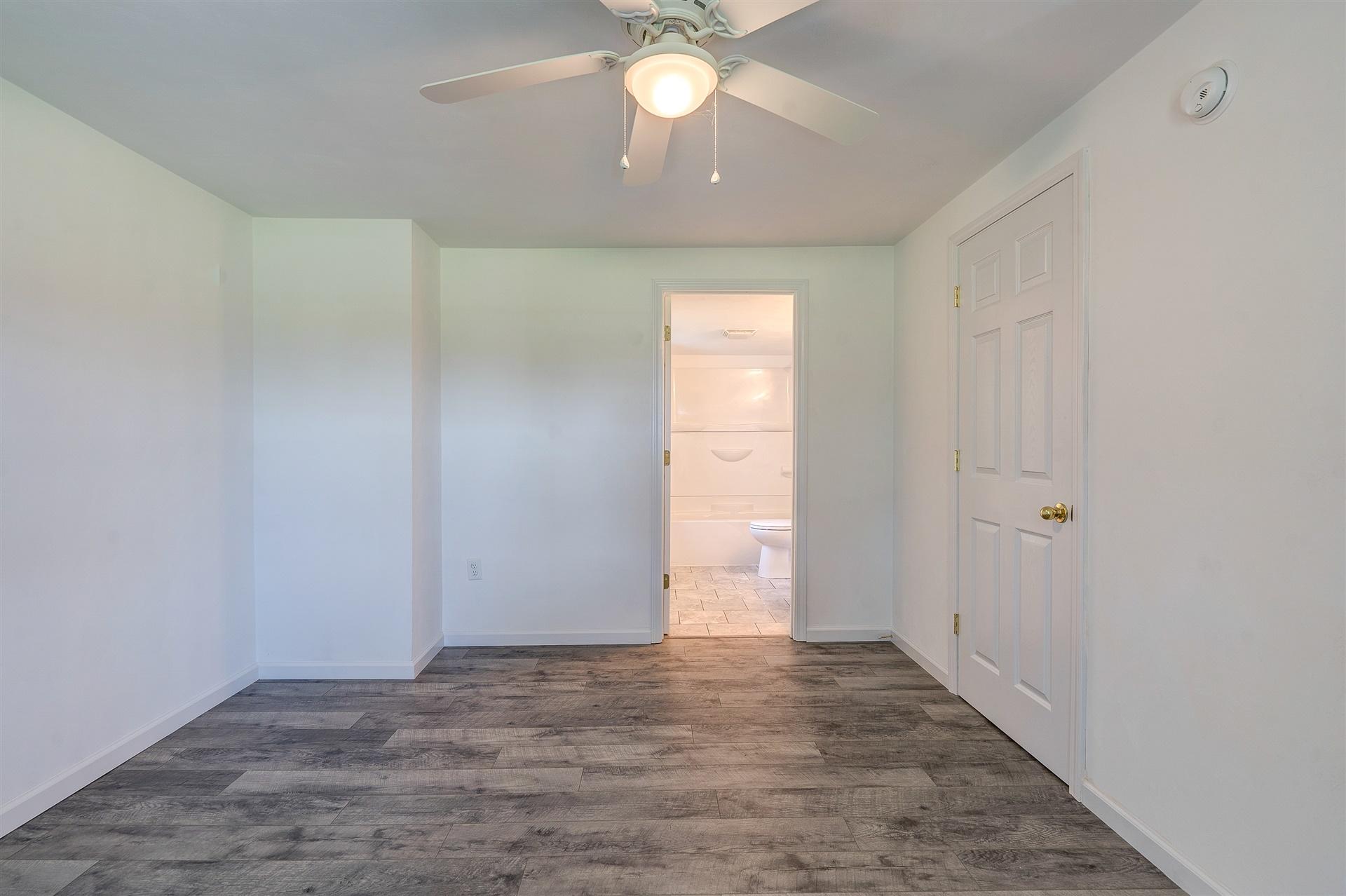2137 Goodview Road Goodview, VA 24095 - Photo 11 of 37 a view of an empty room and window and chandelier fan