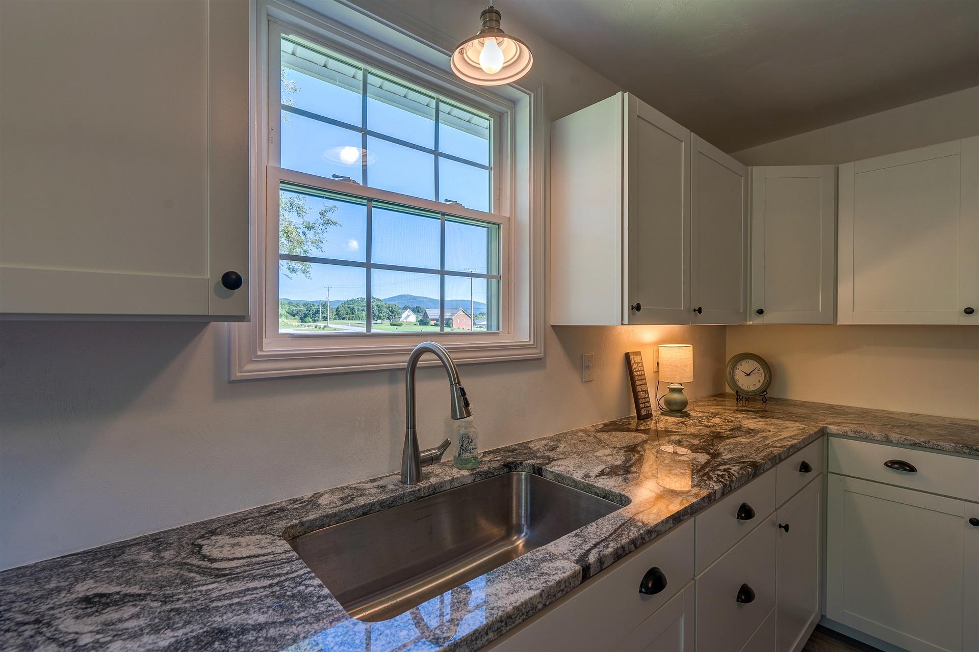 2137 Goodview Road Goodview, VA 24095 - Photo 18 of 37 a kitchen with a sink cabinets and window