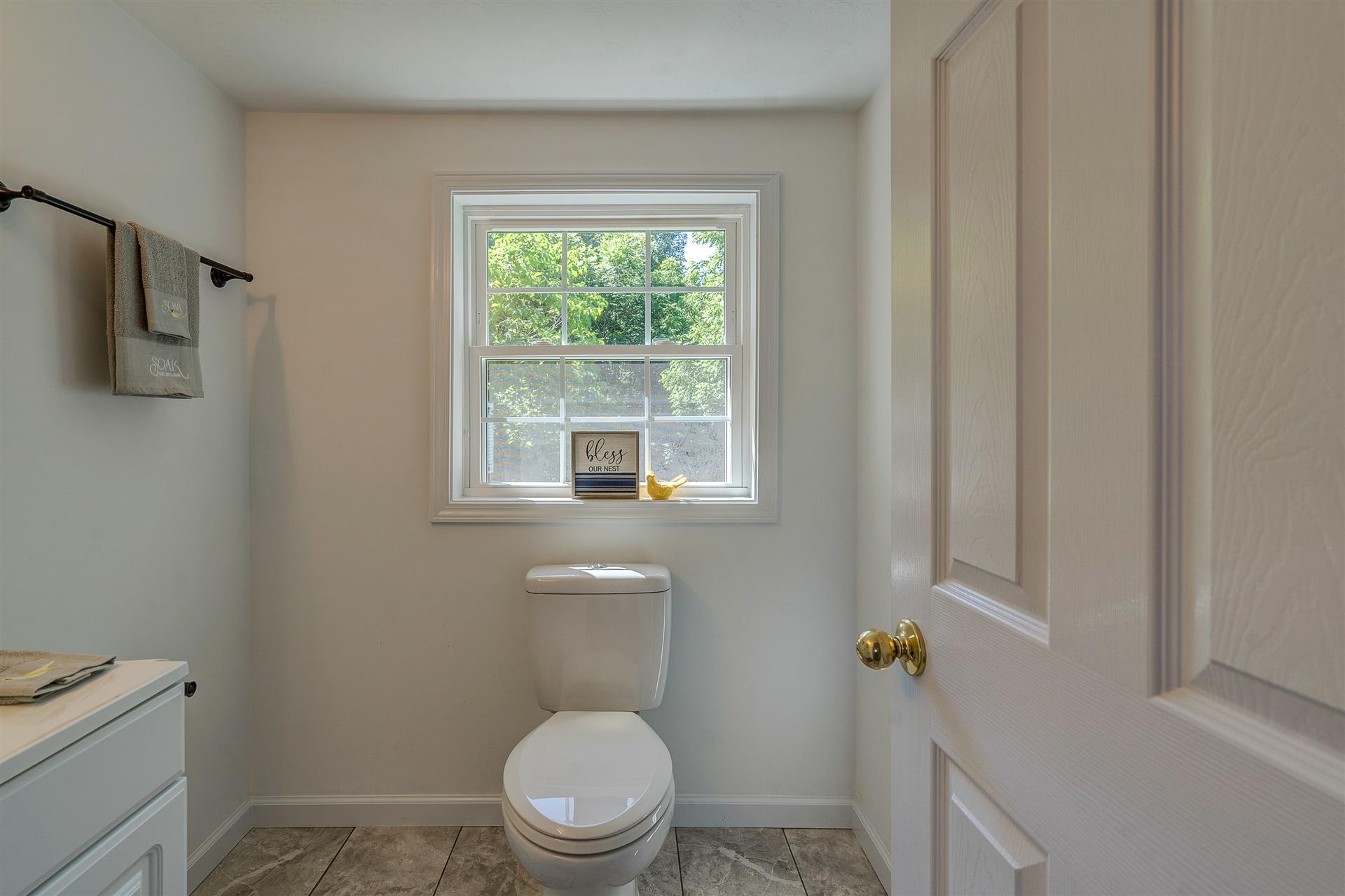 2137 Goodview Road Goodview, VA 24095 - Photo 22 of 37 a white toilet sitting next to a window
