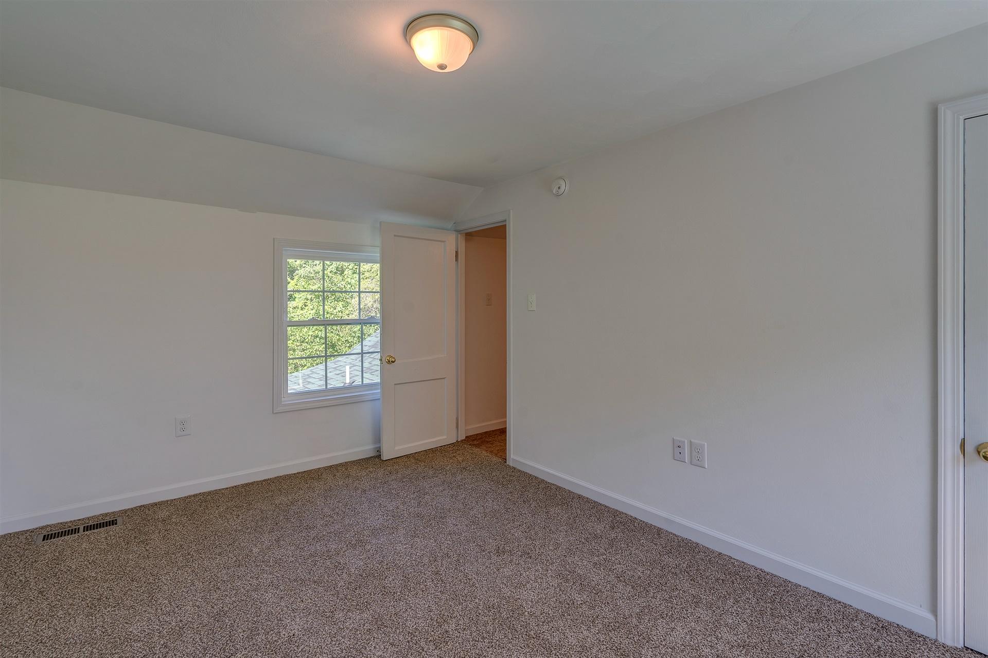 2137 Goodview Road Goodview, VA 24095 - Photo 27 of 37 an empty room with windows
