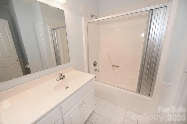 a bathroom with a shower and a sink