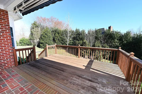 a view of balcony with wooden floor and fence