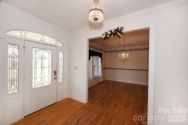a view of a livingroom with wooden floor and a window