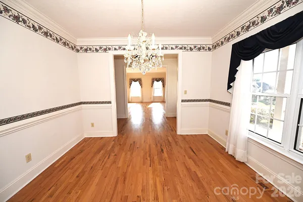 a view of a room with wooden floor and windows