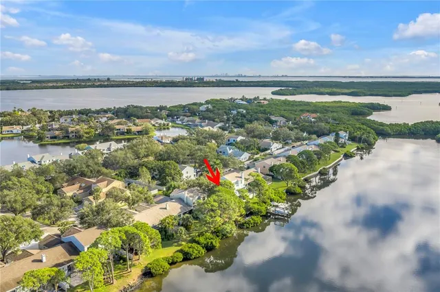 a roof deck with table and chairs and a yard