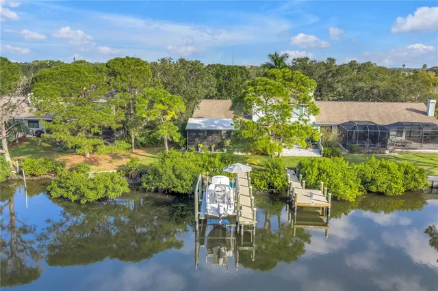 a view of a house with a yard and sitting area