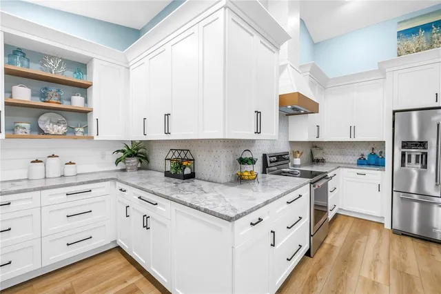 a kitchen with kitchen island granite countertop cabinets and stainless steel appliances