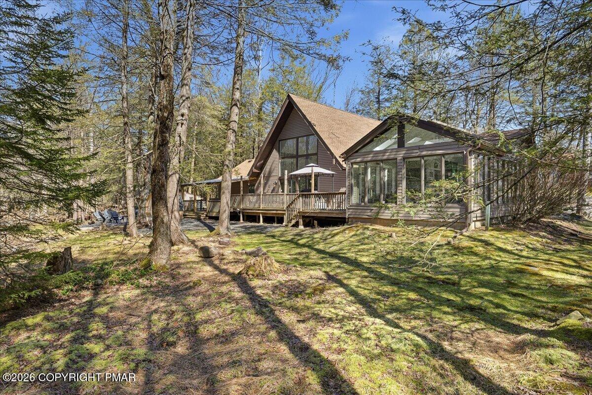 369 Sidney Avenue Pocono Summit, PA 18346 - Photo 1 of 32 a house with trees in the background