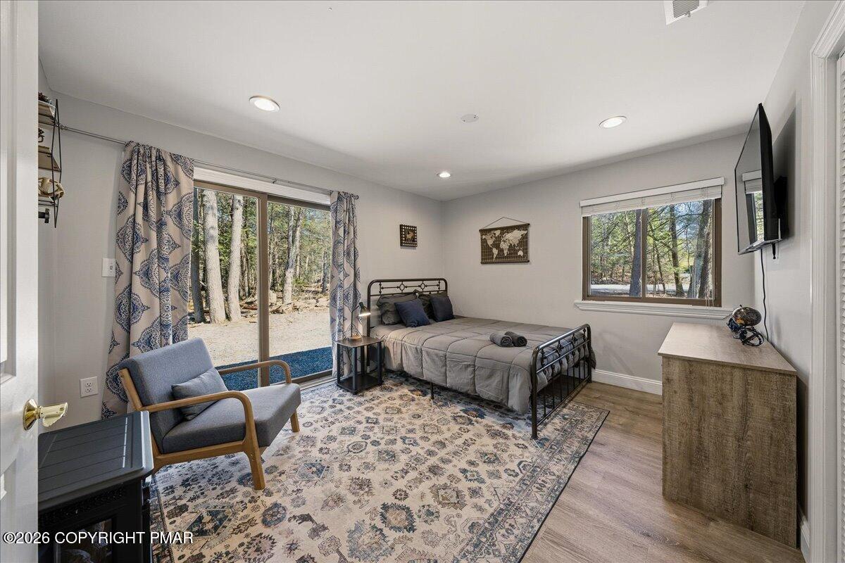 369 Sidney Avenue Pocono Summit, PA 18346 - Photo 14 of 32 a spacious bedroom with a bed and a couch