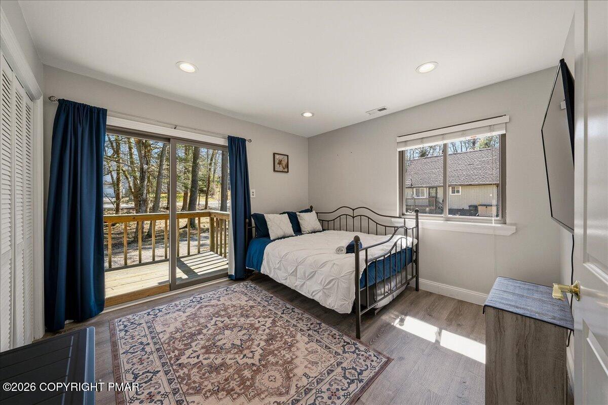 369 Sidney Avenue Pocono Summit, PA 18346 - Photo 16 of 32 a spacious bedroom with a large bed and a window