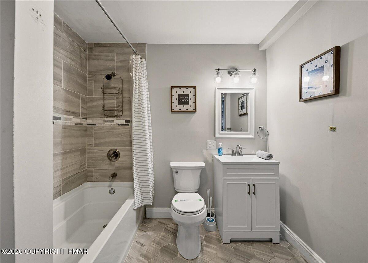369 Sidney Avenue Pocono Summit, PA 18346 - Photo 20 of 32 a bathroom with a toilet a sink a mirror and a bathtub