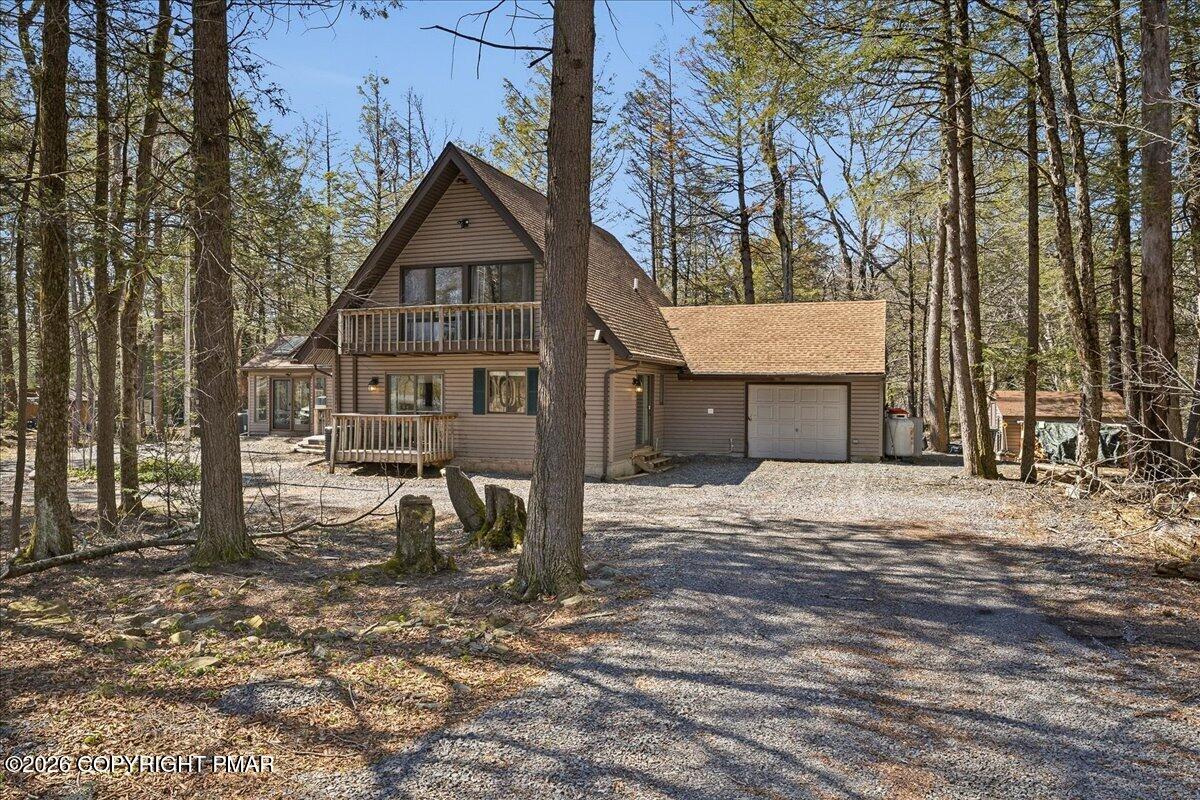 369 Sidney Avenue Pocono Summit, PA 18346 - Photo 2 of 32 a front view of a house with a yard covered in snow