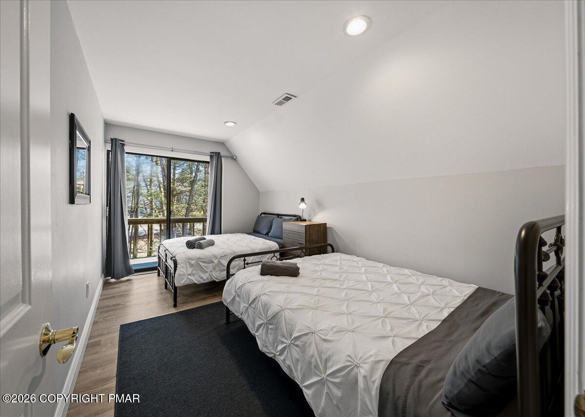 369 Sidney Avenue Pocono Summit, PA 18346 - Photo 22 of 32 a bedroom with two beds and a large window
