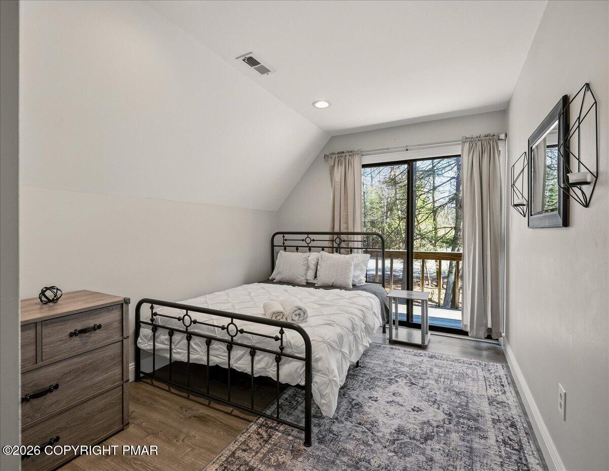 369 Sidney Avenue Pocono Summit, PA 18346 - Photo 23 of 32 a bedroom with a bed next to a window