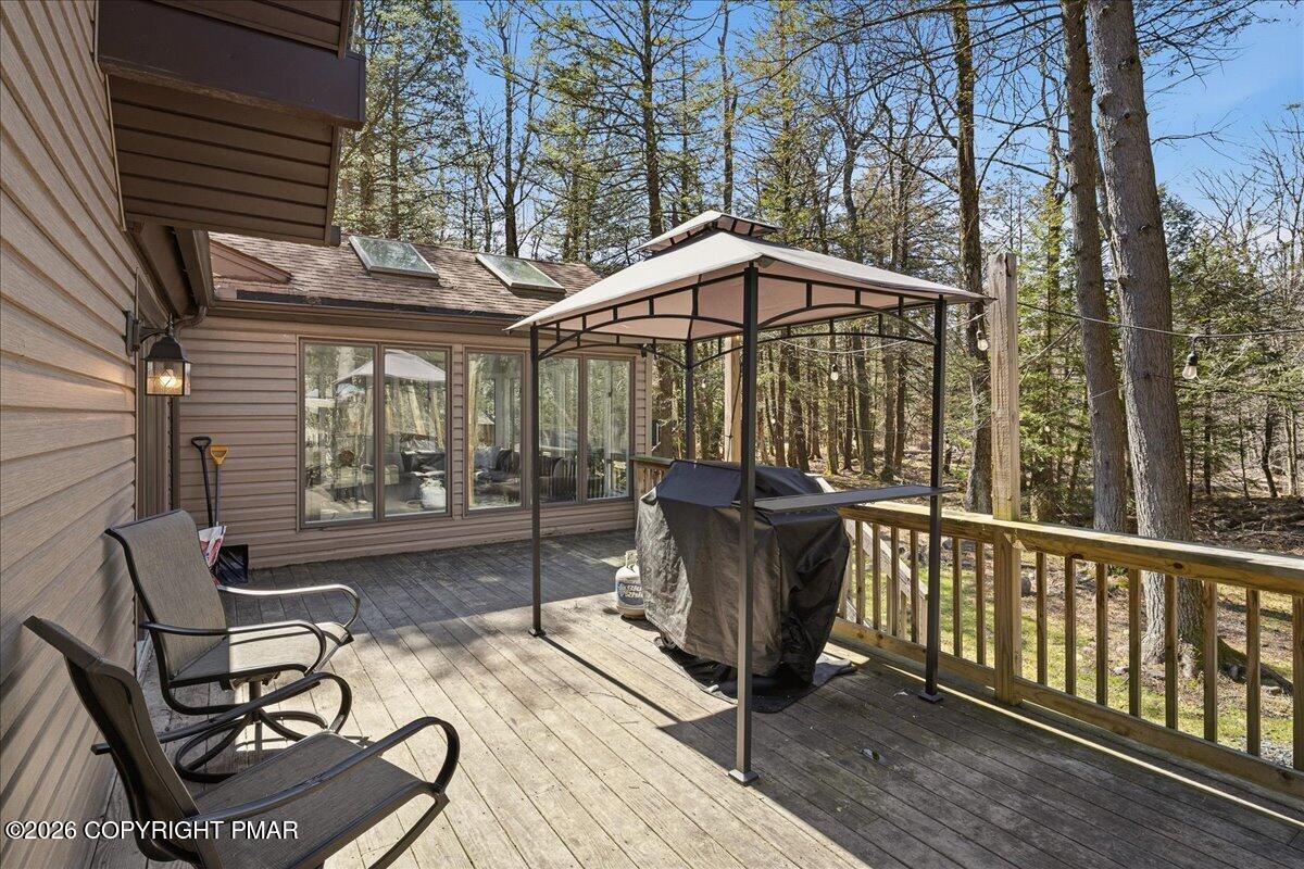369 Sidney Avenue Pocono Summit, PA 18346 - Photo 27 of 32 a view of a chair and tables in the balcony