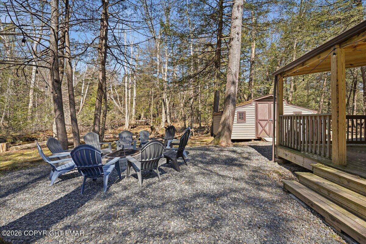 369 Sidney Avenue Pocono Summit, PA 18346 - Photo 29 of 32 a view of a chairs and table in backyard of the house