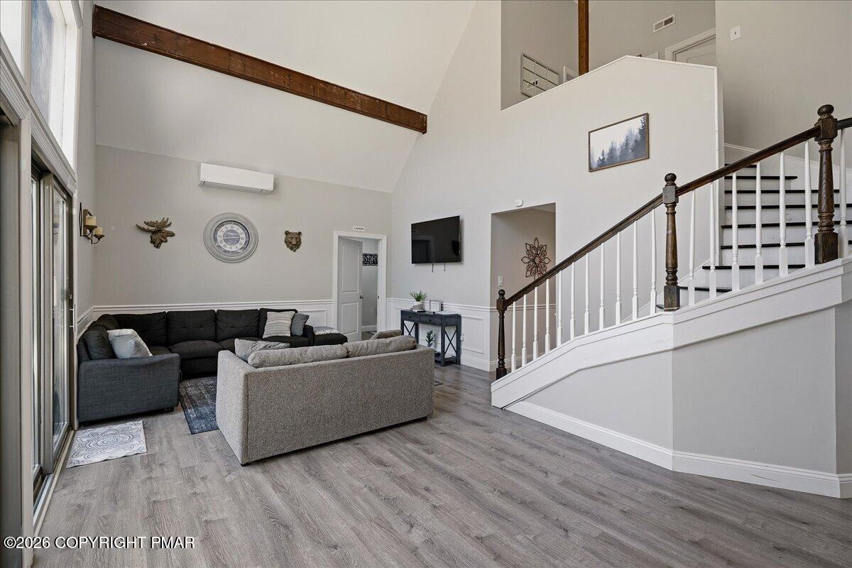 369 Sidney Avenue Pocono Summit, PA 18346 - Photo 6 of 32 a living room with couches and a dining table with wooden floor