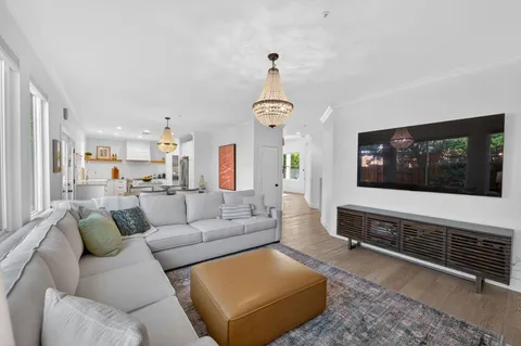 a living room with furniture a rug and a flat screen tv