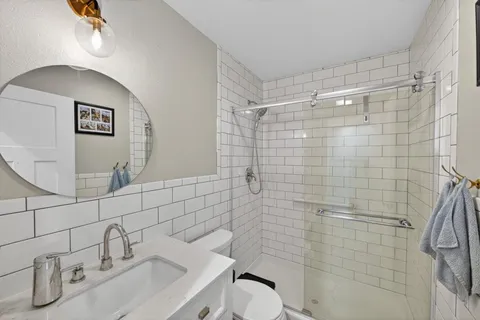 a bathroom with a sink toilet and shower