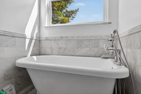a white bath tub sitting next to a white sink