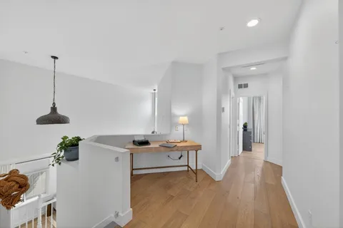 a view of a room with wooden floor