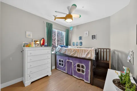 a living room with furniture and baby crib