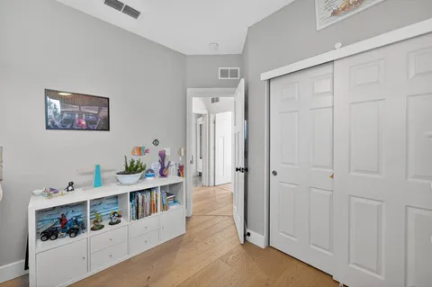 a bedroom with furniture and a large window