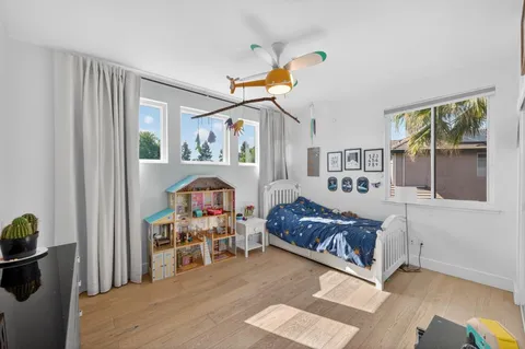 a living room with furniture and paintings on the wall
