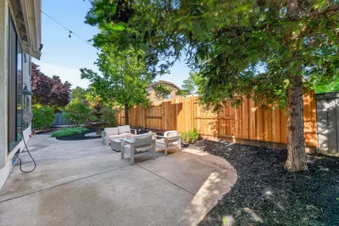 a view of a backyard with sitting area