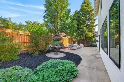 a backyard of a house with outdoor seating