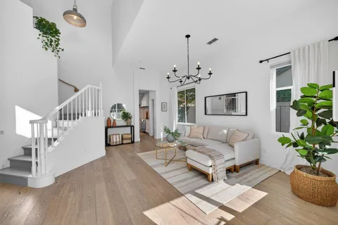 a living room with furniture and a chandelier